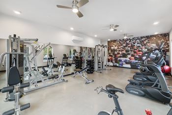 A spacious home gym with a variety of exercise equipment.